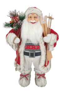 Weihnachtsdekoration St. Nikolaus Rot-Weiß 80cm gekleidet in einen roten Mantel mit Pelz,darunter trägt er einen Pullover mit winterlichem Muster, er hält Skier und einen Korb voller Geschenke